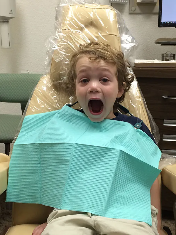A happy children dentistry patient of Gilroy Smiles in the dentist chair
