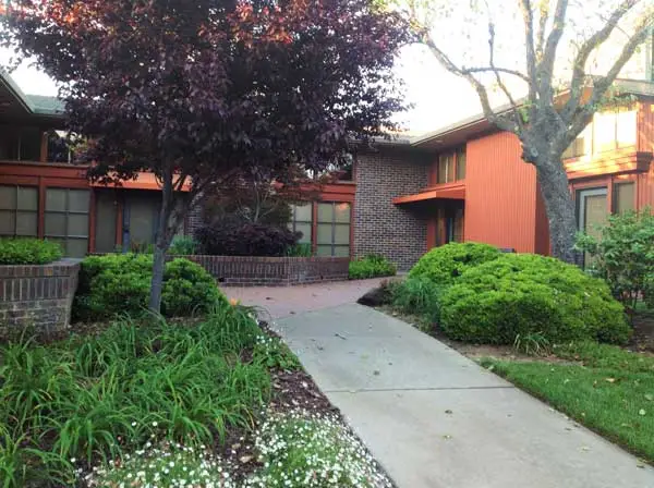 A view of the sidewalk leading to the {PRACTICE_NAME} office