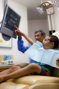 Dr. Chan reviews digital images with a young patient.
